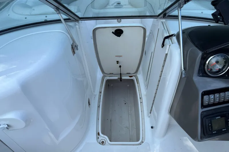 Slide: The Image of 2016 Hurricane SunDeck 2200 DC OB boat interior storage compartment and dashboard view. - 21