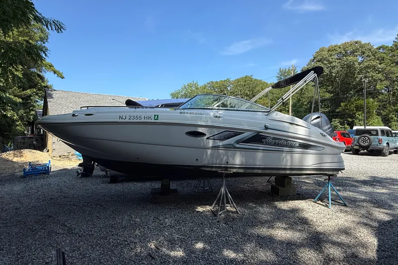 Slide: The Image of 2016 Hurricane SunDeck 2200 DC OB boat on stands, parked outdoors. - 3