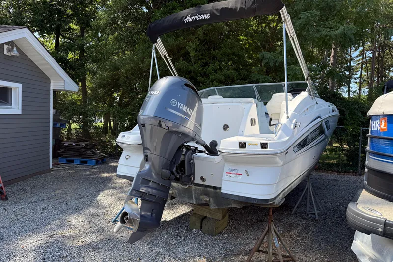 Slide: The Image of 2016 Hurricane SunDeck 2200 DC OB boat with Yamaha outboard motor on a gravel lot. - 7