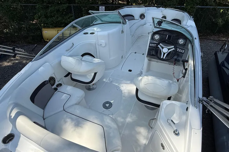 Slide: The Image of 2016 Hurricane SunDeck 2200 DC OB boat interior with white seating and steering console. - 8