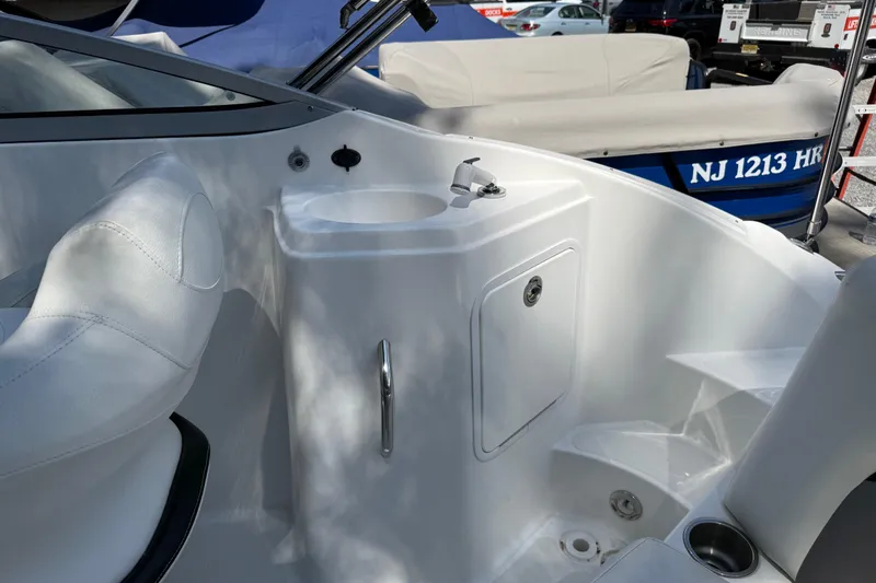 Slide: The Image of 2016 Hurricane SunDeck 2200 DC OB boat interior with sink and seating area. - 9