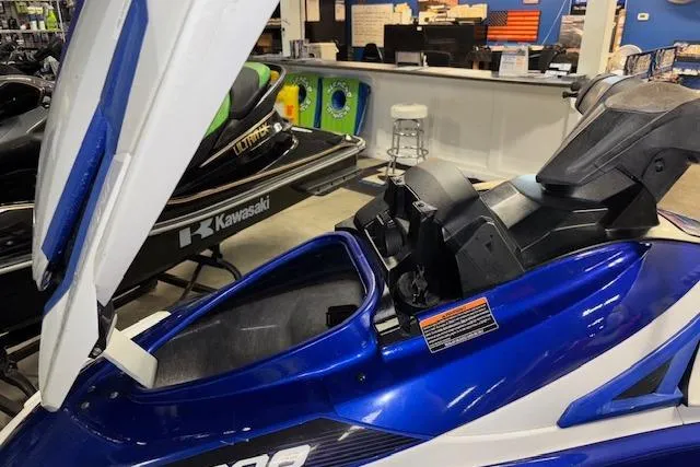 Slide: The Image of 2018 Yamaha WaveRunner GP1800 in showroom, blue with open storage compartment. - 10