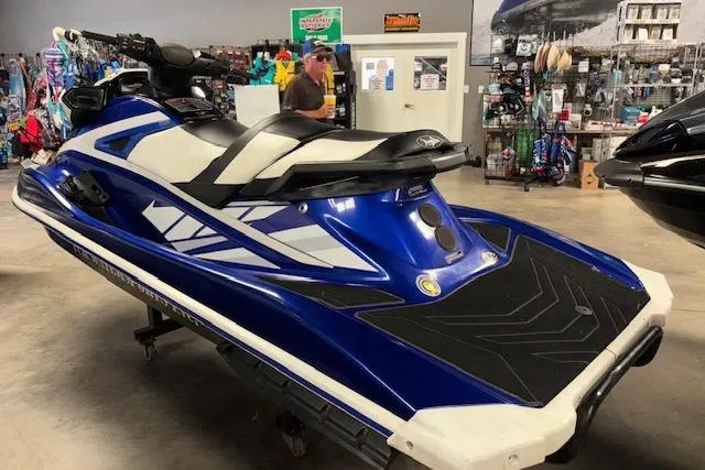 Slide: The Image of 2018 Yamaha WaveRunner GP1800 in showroom, blue and white design, side view. - 3