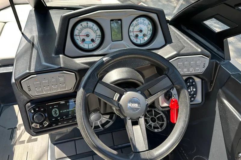 Slide: The Image of 2018 Axis T22 boat dashboard with steering wheel, gauges, and control panels. - 10