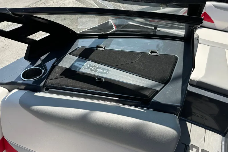 Slide: The Image of Interior view of 2018 Axis T22 boat dashboard with cup holder and storage compartment. - 12