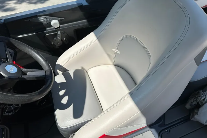 Slide: The Image of 2018 Axis T22 boat interior with steering wheel and white seat. - 14