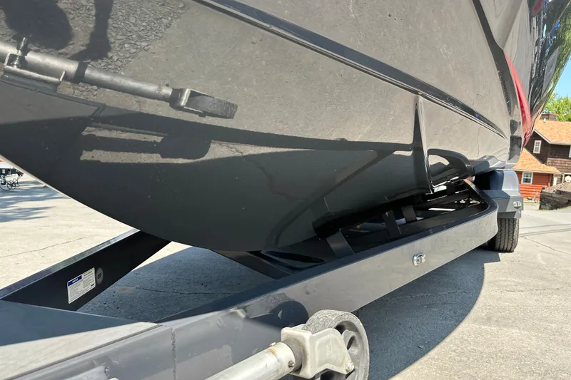 Slide: The Image of 2018 Axis T22 boat on trailer, close-up view of hull and wheels. - 20