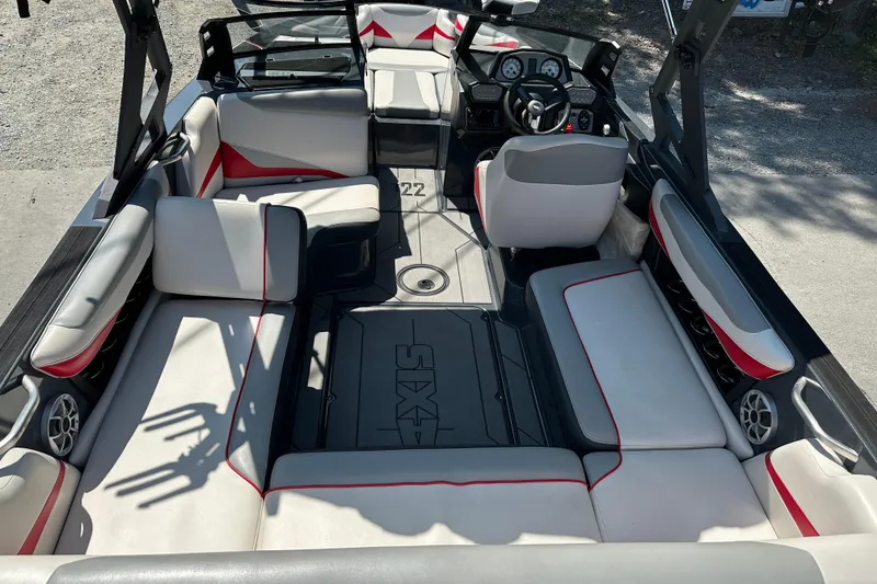 Slide: The Image of 2018 Axis T22 boat interior with white and red seating, steering wheel, and dashboard. - 8