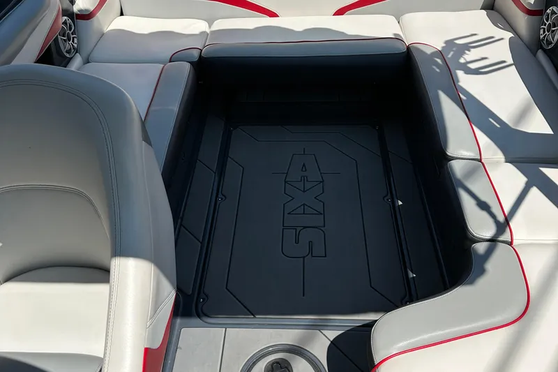 Slide: The Image of 2018 Axis T22 boat interior with gray and red seating, featuring Axis logo. - 9