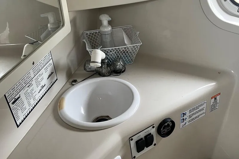 Slide: The Image of 2002 Four Winns 268 Vista boat bathroom sink with soap dispenser and control panel. - 16