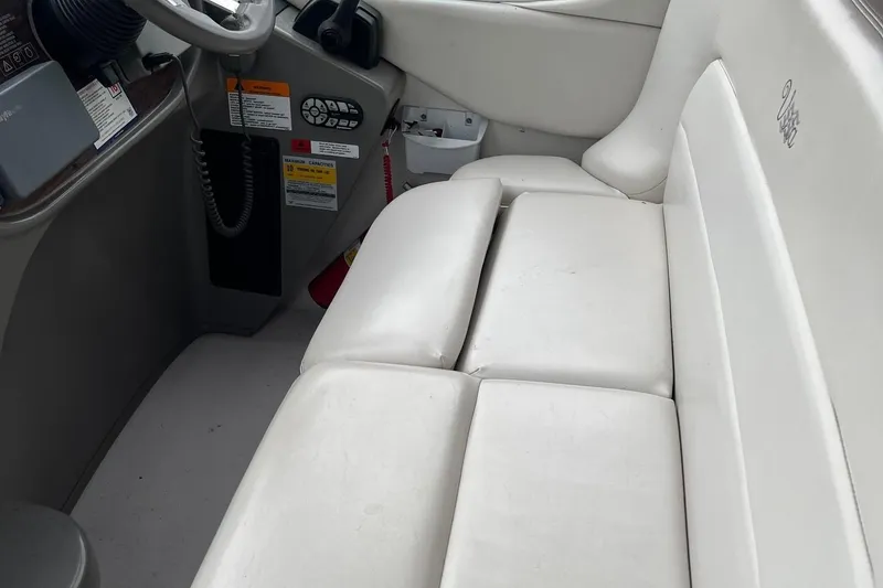 Slide: The Image of 2002 Four Winns 268 Vista boat interior with white seating and control panel. - 8