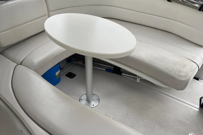 Slide: The Image of 2002 Four Winns 268 Vista boat interior with white seating and table. - 9