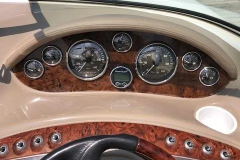 Slide: The Image of Dashboard of a 2002 Maxum 2100 SC boat with wood paneling and gauges. - 11