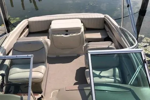 Slide: The Image of 2002 Maxum 2100 SC boat interior with beige seating and open cockpit. - 5