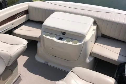 Slide: The Image of 2002 Maxum 2100 SC boat interior with beige seating and cup holders. - 6