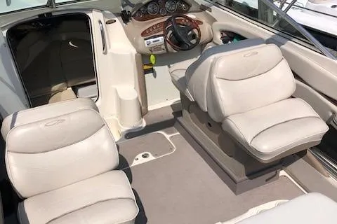 Slide: The Image of 2002 Maxum 2100 SC boat interior with plush seating and modern dashboard. - 7