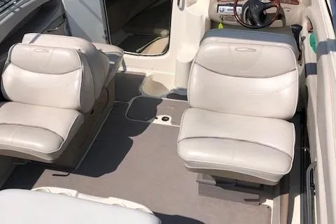 Slide: The Image of 2002 Maxum 2100 SC boat interior with white leather seats and steering wheel. - 8