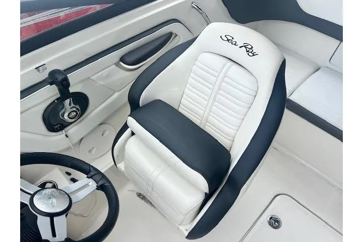 Slide: The Image of Captain's seat of 2018 Sea Ray 19 SPX OB boat, featuring black and white upholstery. - 10