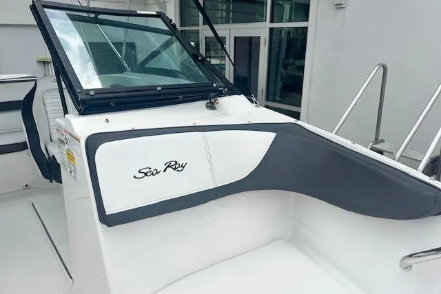 Slide: The Image of 2018 Sea Ray 19 SPX OB boat interior with windshield and branding. - 13