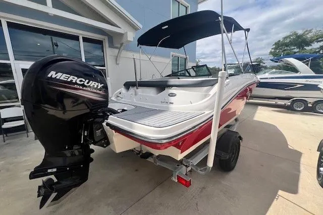 Slide: The Image of 2018 Sea Ray 19 SPX OB boat with Mercury outboard motor, parked on a trailer. - 2