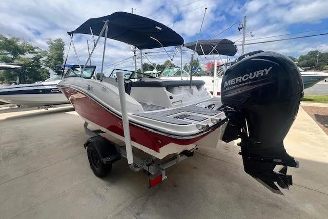 Slide: The Image of 2018 Sea Ray 19 SPX OB boat with Mercury outboard motor, parked on a trailer. - 3
