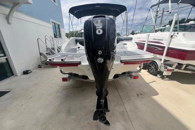 Slide: The Image of 2018 Sea Ray 19 SPX OB boat with 150 HP outboard motor, docked outdoors. - 4