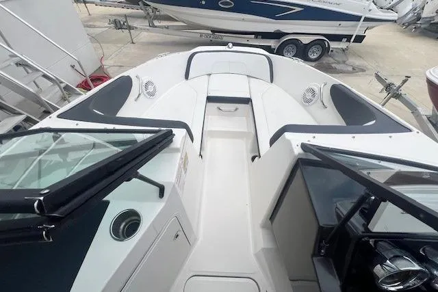 Slide: The Image of 2018 Sea Ray 19 SPX OB boat interior with seating and windshield, docked on trailer. - 8