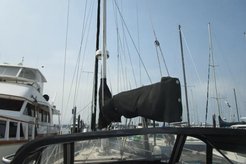 Slide: The Image of 1989 Catalina 36 sailboat docked at marina, mast and rigging visible. - 11