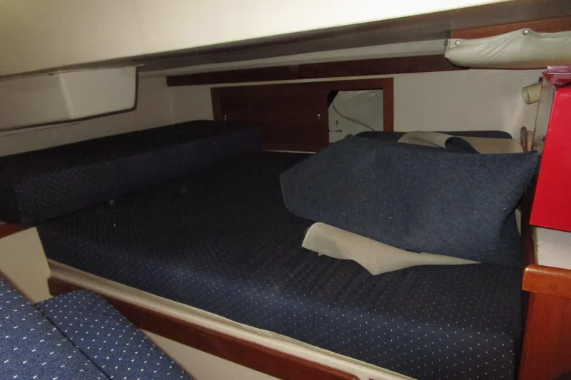Slide: The Image of Interior cabin of a 1989 Catalina 36 sailboat with blue cushions. - 13
