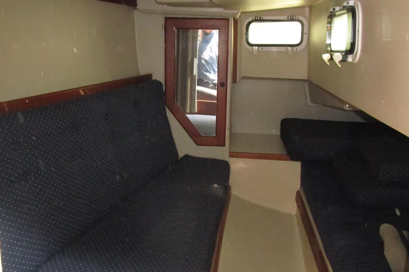 Slide: The Image of Interior cabin of a 1989 Catalina 36 sailboat with seating and porthole. - 14