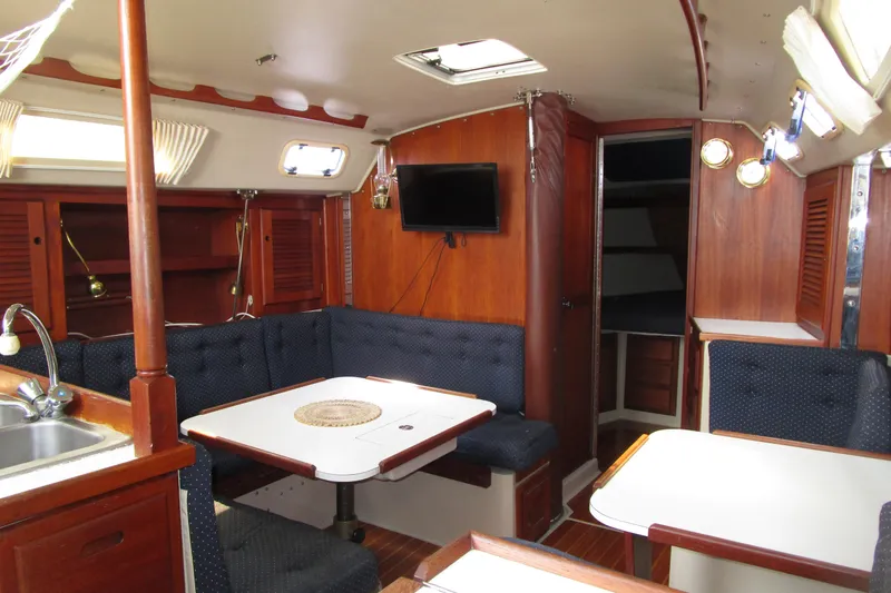 Slide: The Image of Interior of a 1989 Catalina 36 sailboat with cozy seating and wooden finishes. - 18