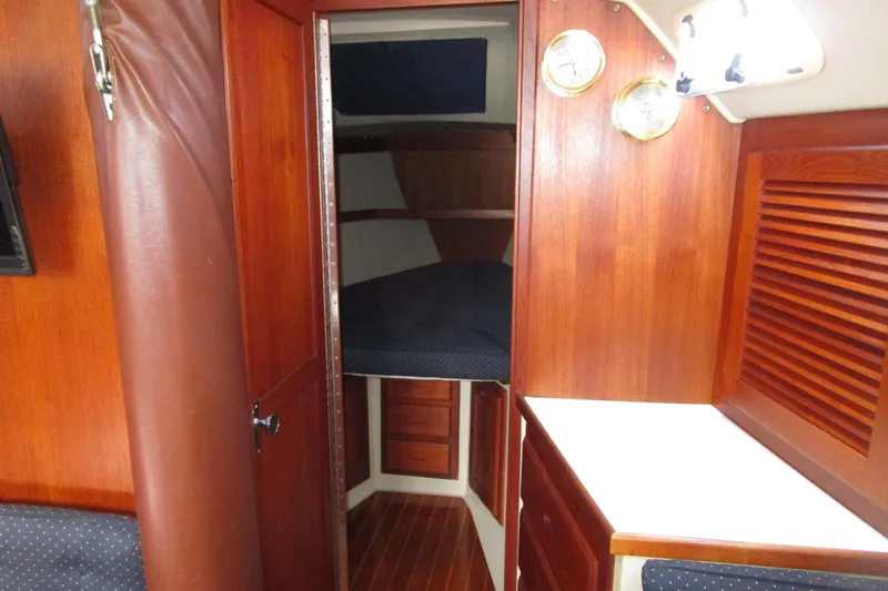 Slide: The Image of Interior of 1989 Catalina 36 sailboat with wooden cabinetry and cozy sleeping quarters. - 19