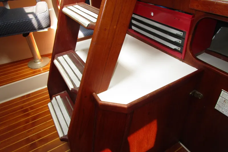 Slide: The Image of Interior of 1989 Catalina 36 sailboat showing wooden steps and seating area. - 26