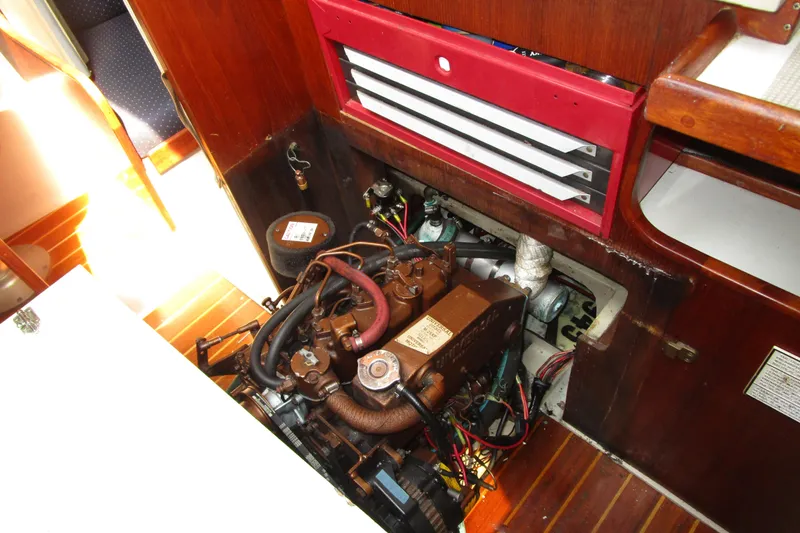 Slide: The Image of Engine compartment of a 1989 Catalina 36 sailboat, featuring a well-maintained marine engine. - 27