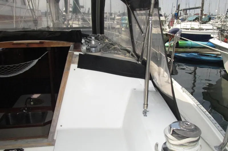 Slide: The Image of 1989 Catalina 36 sailboat cockpit with winch, ropes, and marina view. - 4