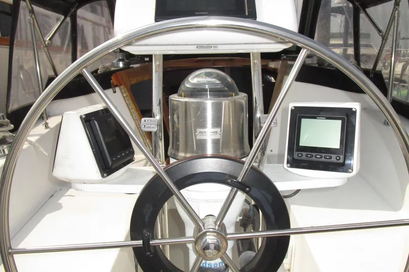 Slide: The Image of Cockpit of 1989 Catalina 36 sailboat with steering wheel and navigation instruments. - 6