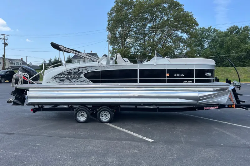 The Image of 2014 Manitou 23 X-Plode pontoon boat on trailer in parking lot. - 1