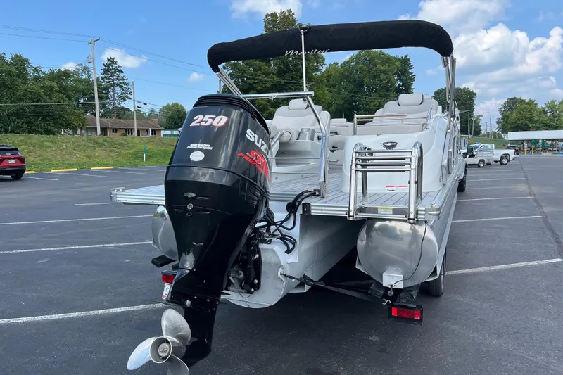 Slide: The Image of 2014 Manitou 23 X-Plode pontoon boat with Suzuki 250 outboard motor in parking lot. - 10