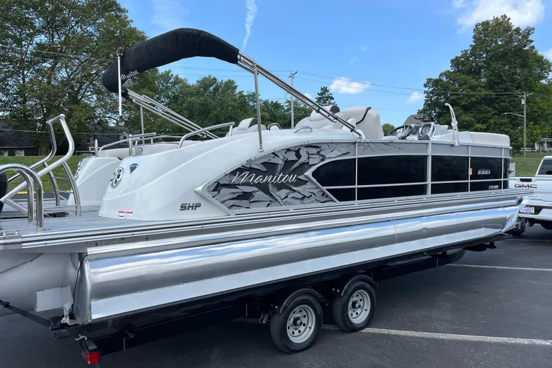 Slide: The Image of 2014 Manitou 23 X-Plode pontoon boat on trailer, parked outdoors. - 11