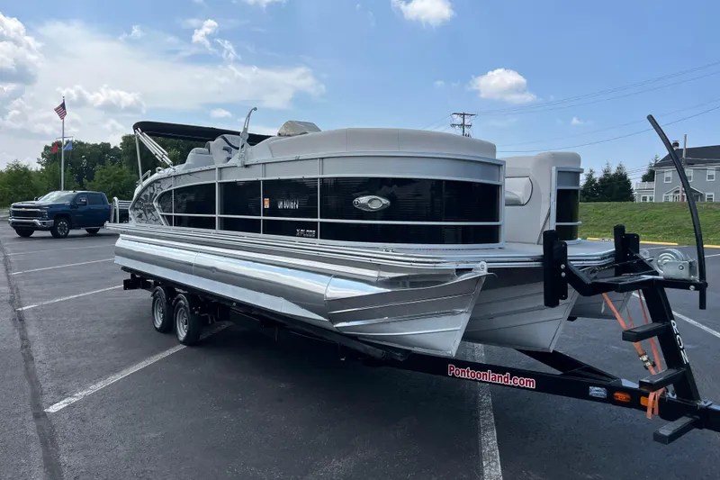 Slide: The Image of 2014 Manitou 23 X-Plode pontoon boat on trailer in parking lot. - 2