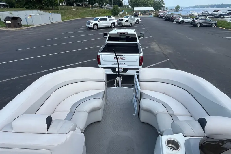 Slide: The Image of 2014 Manitou 23 X-Plode pontoon boat hitched to a GMC truck in a parking lot. - 6