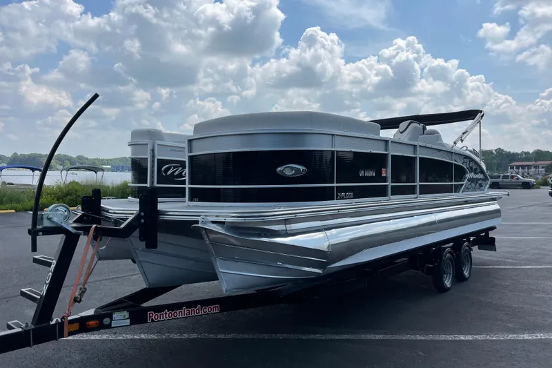 Slide: The Image of 2014 Manitou 23 X-Plode pontoon boat on trailer under cloudy sky. - 7