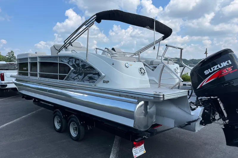 Slide: The Image of 2014 Manitou 23 X-Plode pontoon boat with Suzuki outboard motor on trailer. - 9