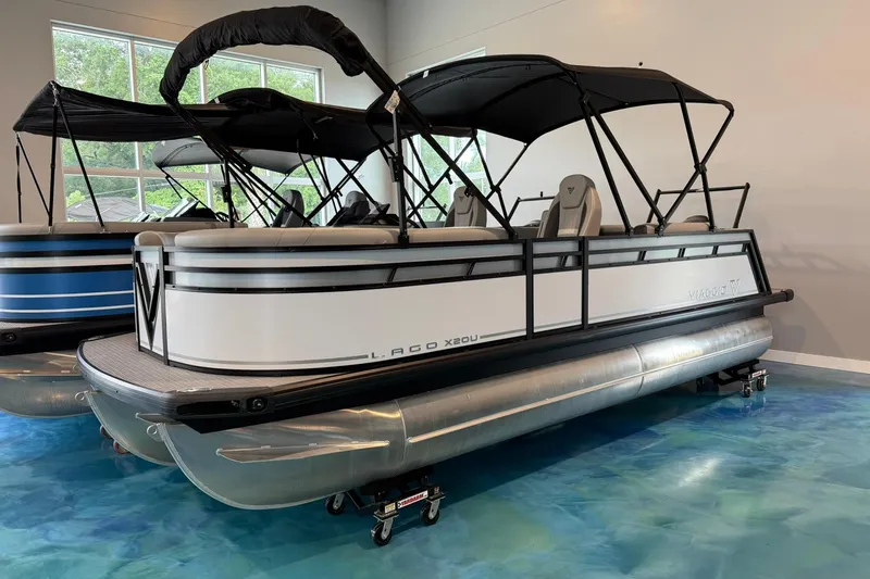 The Image of 2026 Viaggio Lago X-U pontoon boat with black canopy in showroom. - 1