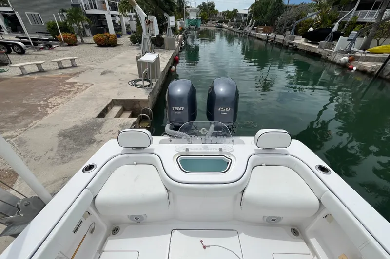 Slide: The Image of 2015 Contender 24 Sport boat with dual 150 engines docked in a canal. - 10