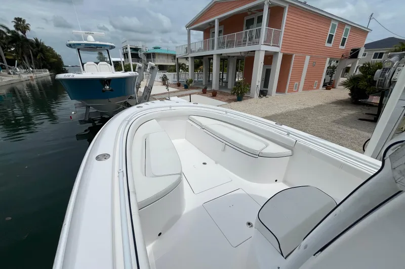 Slide: The Image of 2015 Contender 24 Sport boat docked near a waterfront house. - 5