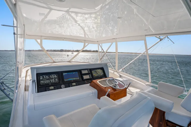 Slide: The Image of Helm of 2004 Sculley Custom Carolina 58' Sportfish with navigation displays, overlooking ocean. - 10