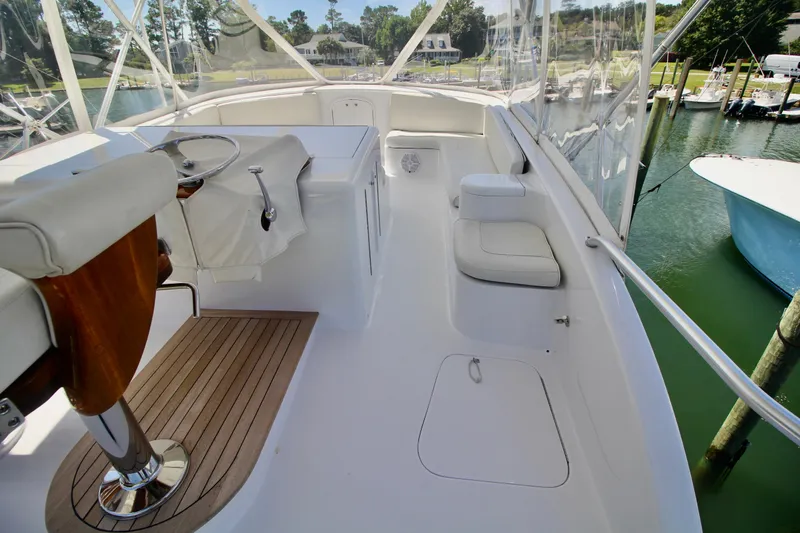 Slide: The Image of 2004 Sculley Custom Carolina 58' Sportfish yacht interior with helm and seating area. - 17