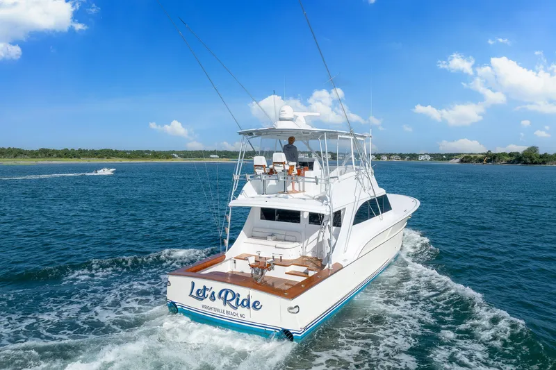 Slide: The Image of 2004 Sculley Custom Carolina 58' Sportfish yacht cruising on blue ocean waters. - 2