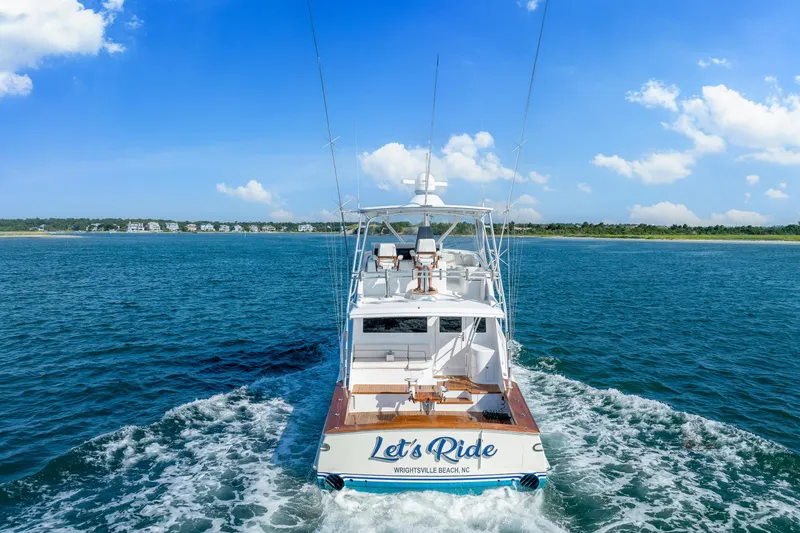 Slide: The Image of Sculley Custom Carolina 58' Sportfish boat cruising near Wrightsville Beach, NC, under clear skies. - 3